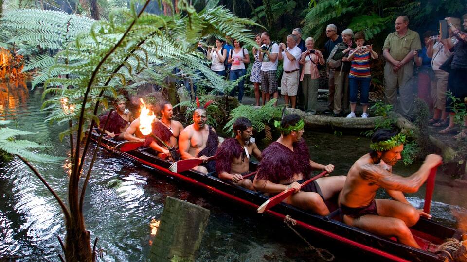 Rotorua featuring a river or creek and indigenous culture as well as a small group of people