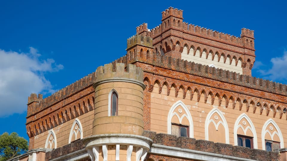 A historic building with a crenellated roof and arched windows.