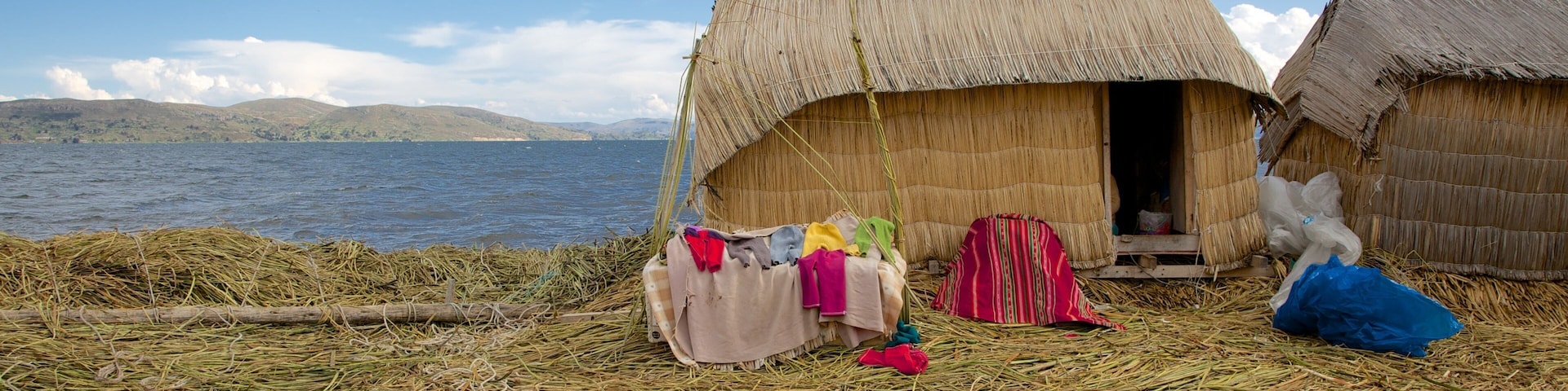 Lake Titicaca which includes a small town or village and a lake or waterhole