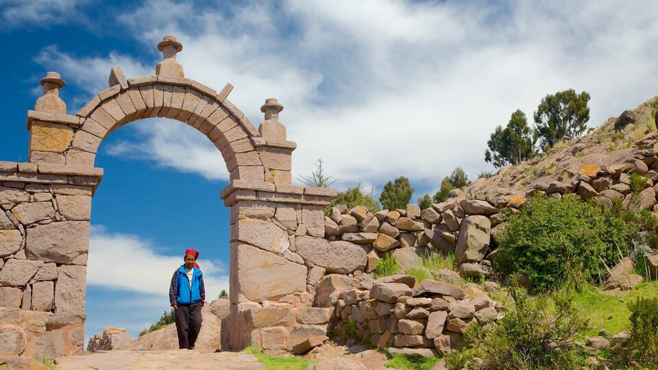 A stone archway with a person walking through it.