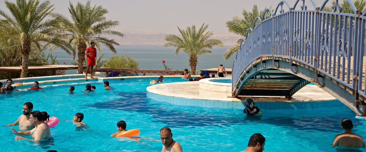 Sweimeh which includes general coastal views, a pool and swimming
