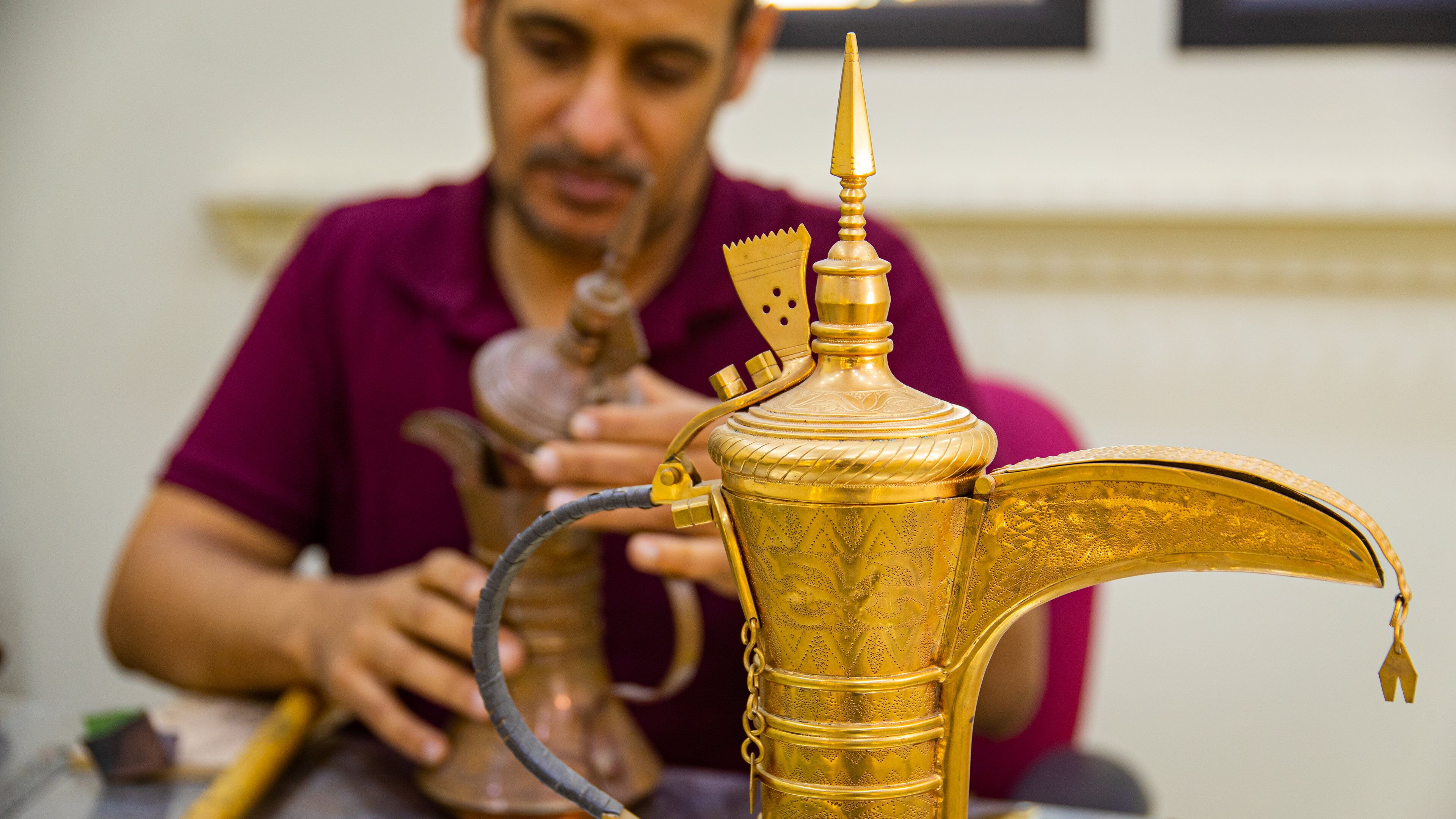 Al Jasra Handicraft Centre featuring interior views as well as an individual male