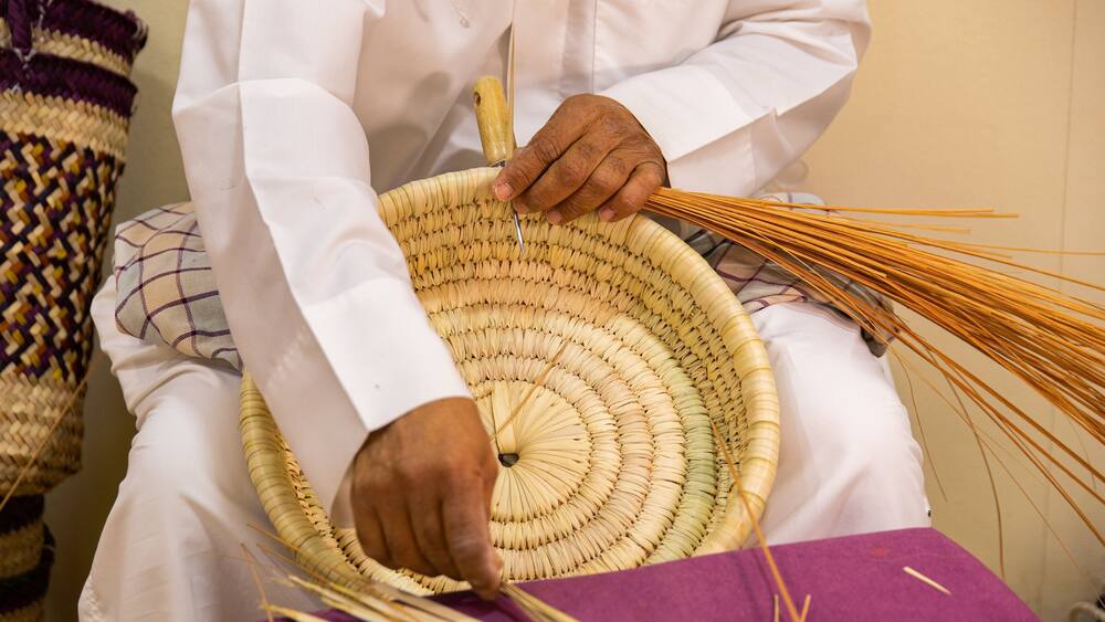 Al Jasra Handicraft Centre featuring markets as well as an individual male