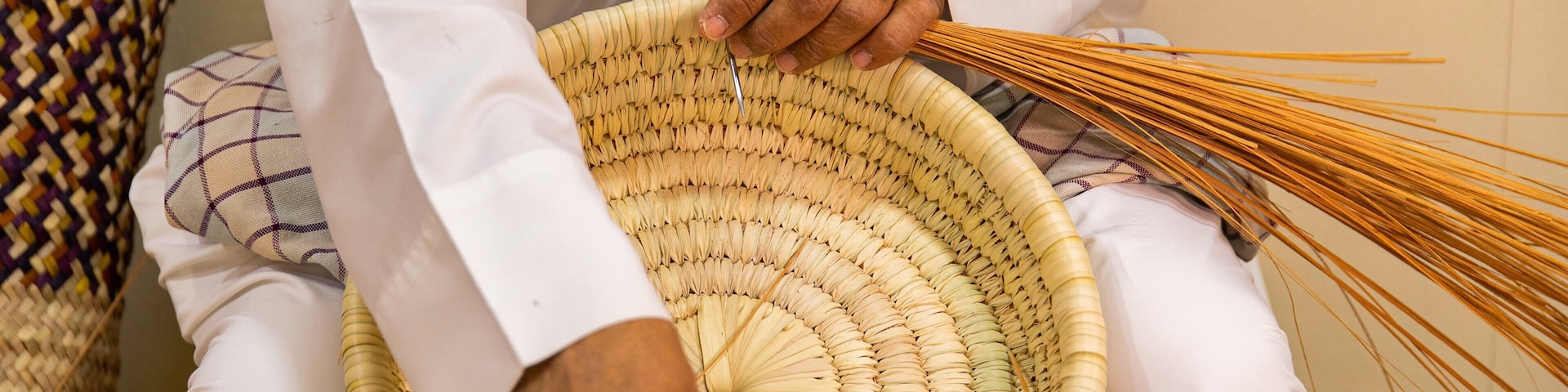 Al Jasra Handicraft Centre featuring markets as well as an individual male