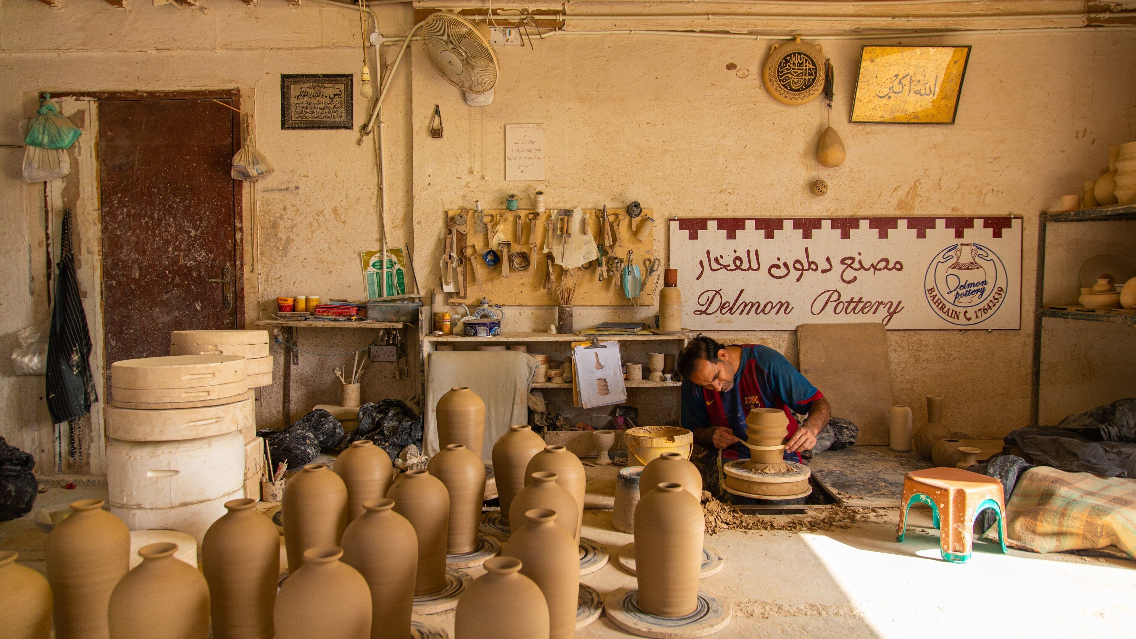 A pottery workshop with clay pots and tools.