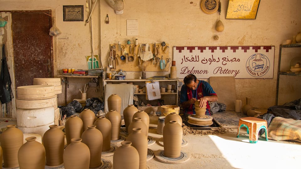A pottery workshop with various clay pots and tools.