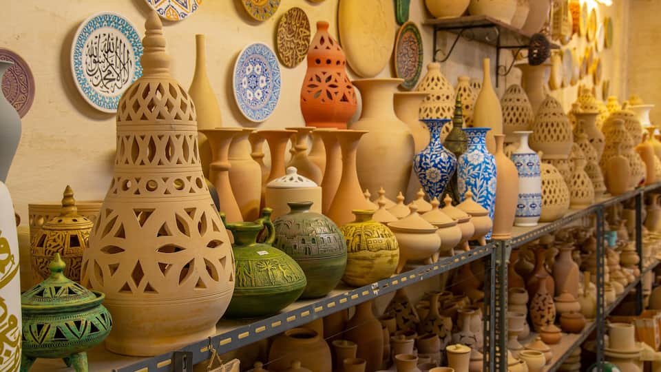 A variety of traditional pottery and ceramics displayed on shelves.