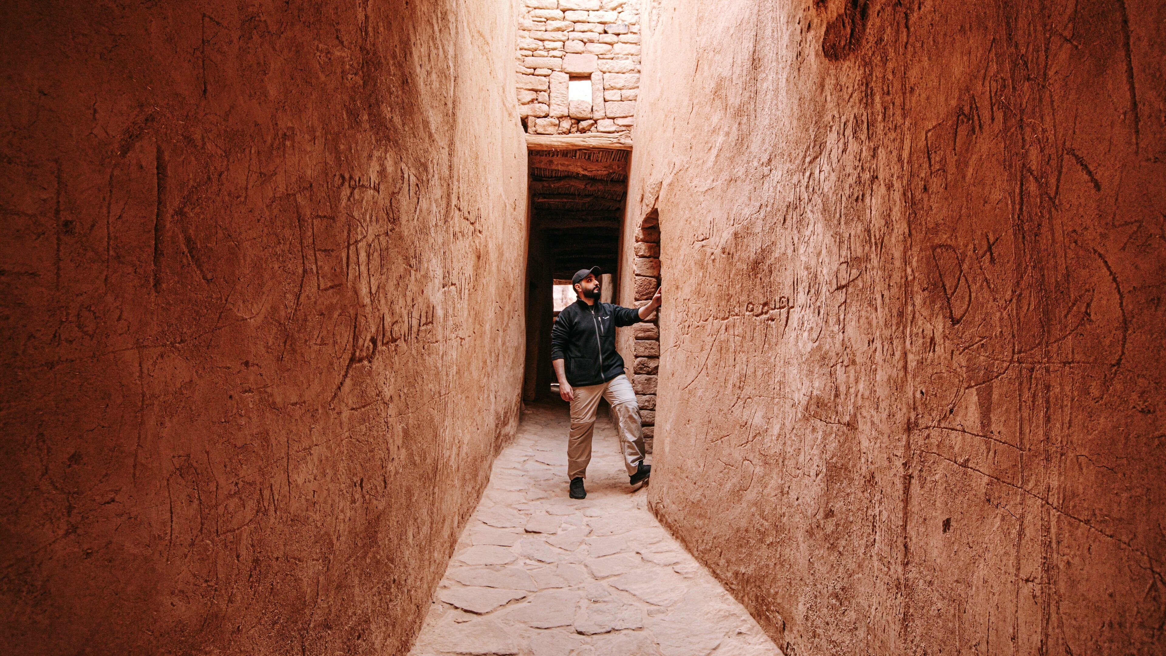 AlUla Old Town which includes street scenes and heritage elements as well as an individual male