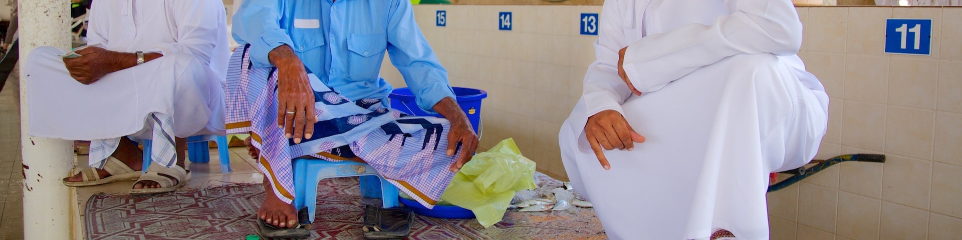 Mutrah Fish Market featuring interior views, food and markets