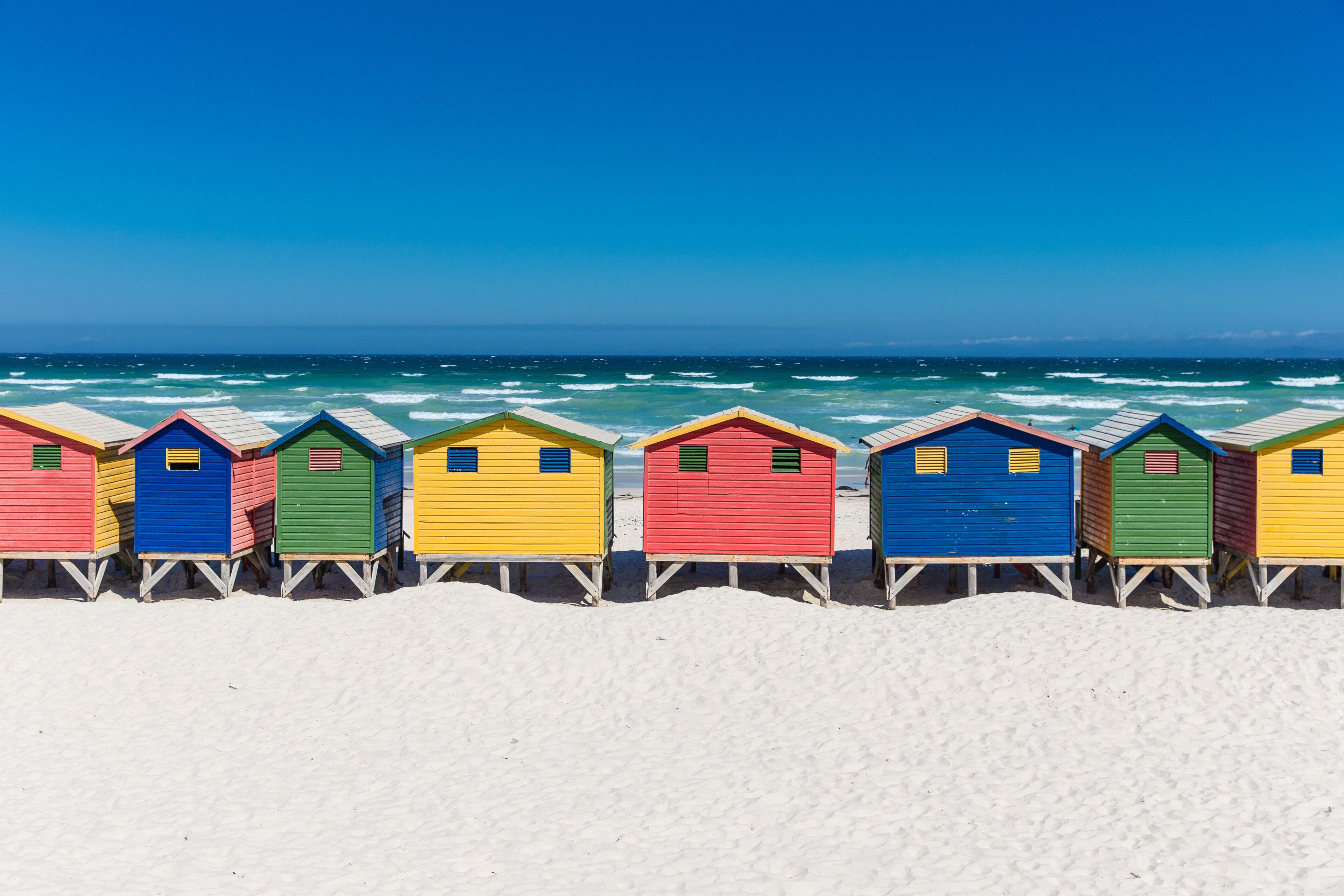 Colored Beach Houses in Muizenberg under blue sky, Cape Town, South Africa, beach huts