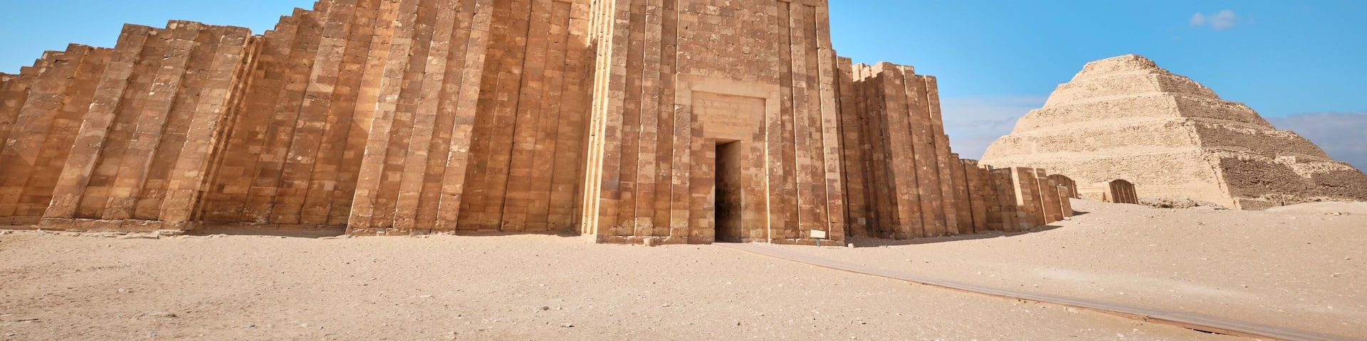 Saqqara, Egypt - January 2, 2024: Entrance to the mortuary temple near the pyramid of Djoser in Saqqara. Roofed colonnade entrance of Step Pyramid