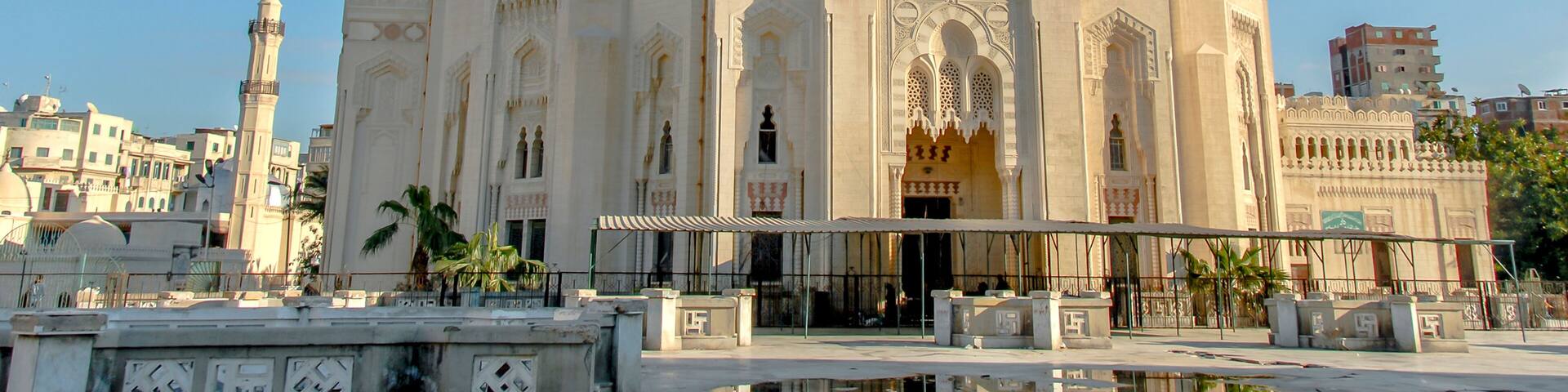 A large, ornate mosque with two domes and a tall minaret.