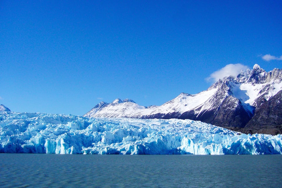 A glacier with a mountain range in the background.