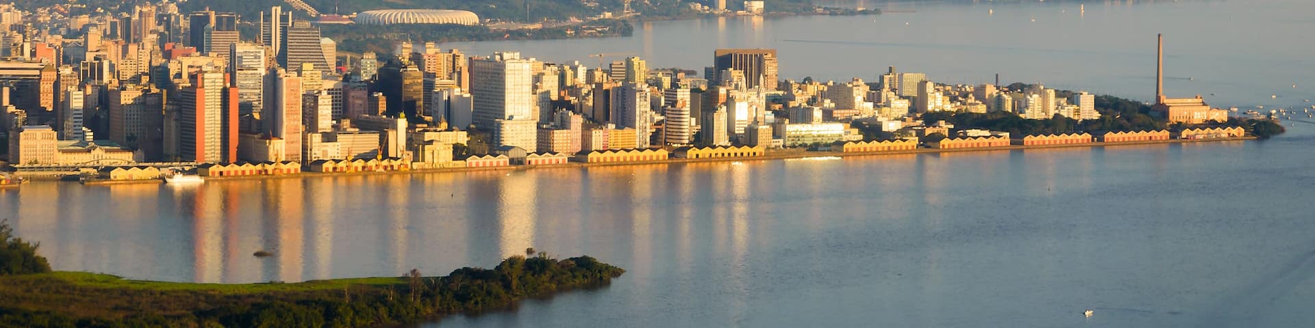 Porto Alegre, Brazil skyline. City located in Rio Grande do Sul State. Porto Alegre downtown and harbor reflecting in Guaiba Lake / River.