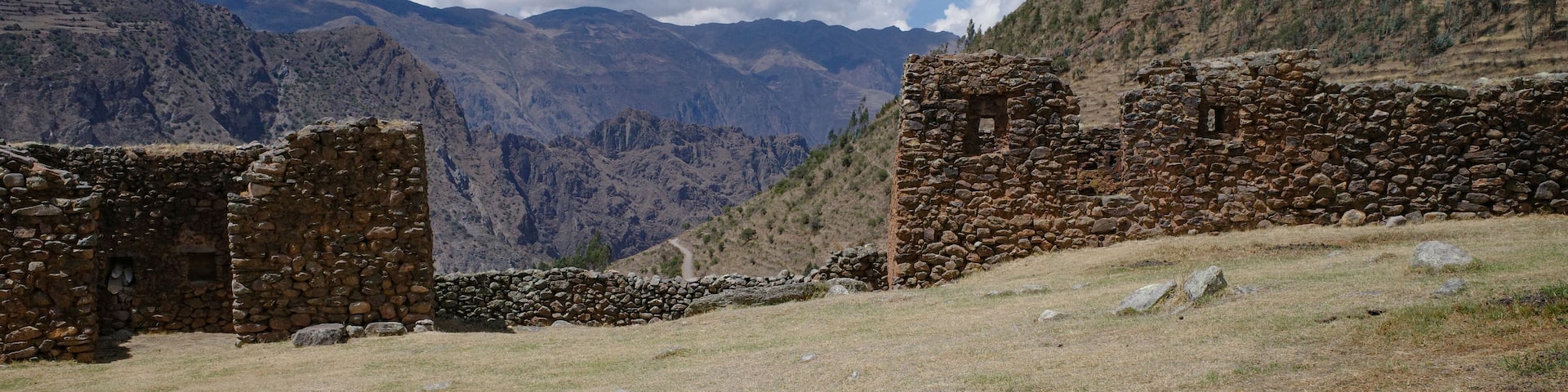 Ancient stone ruins in a mountainous landscape with a clear sky.