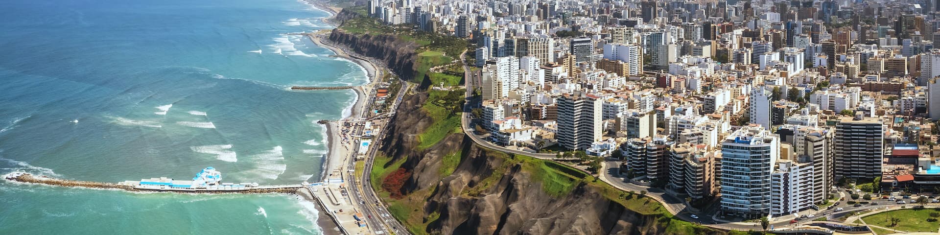 Aerial panorama of Lima, Peru along the coast also known as Circuito de Playas de la Costa Verde at a golden hour sunset