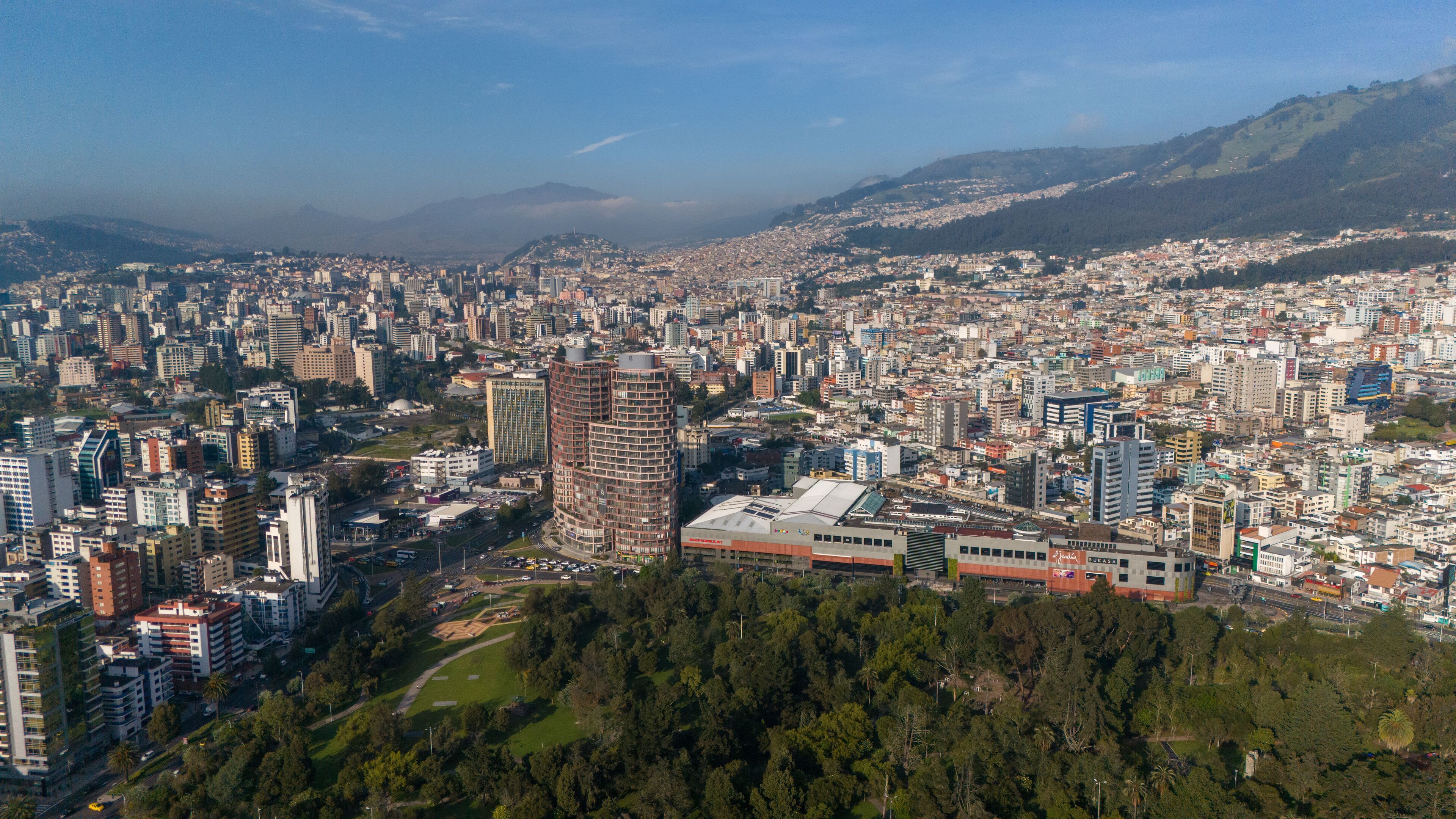 Aerial drone view of Quito capital city of Ecuador South America Parque La Carolina Sunrise early morning traffic