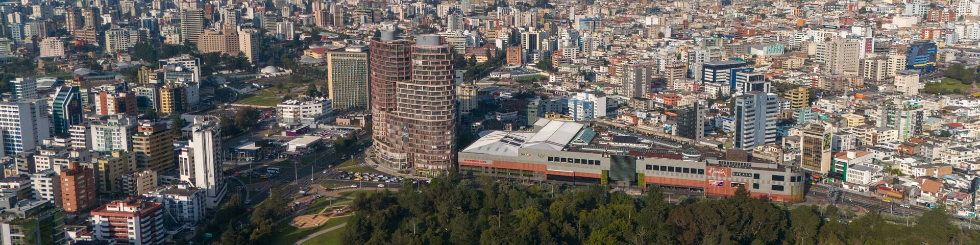 Aerial drone view of Quito capital city of Ecuador South America Parque La Carolina Sunrise early morning traffic