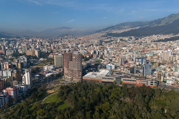 Aerial drone view of Quito capital city of Ecuador South America Parque La Carolina Sunrise early morning traffic