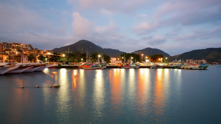 Cais Turistico de Santa Luzia featuring a bay or harbor, night scenes and a small town or village