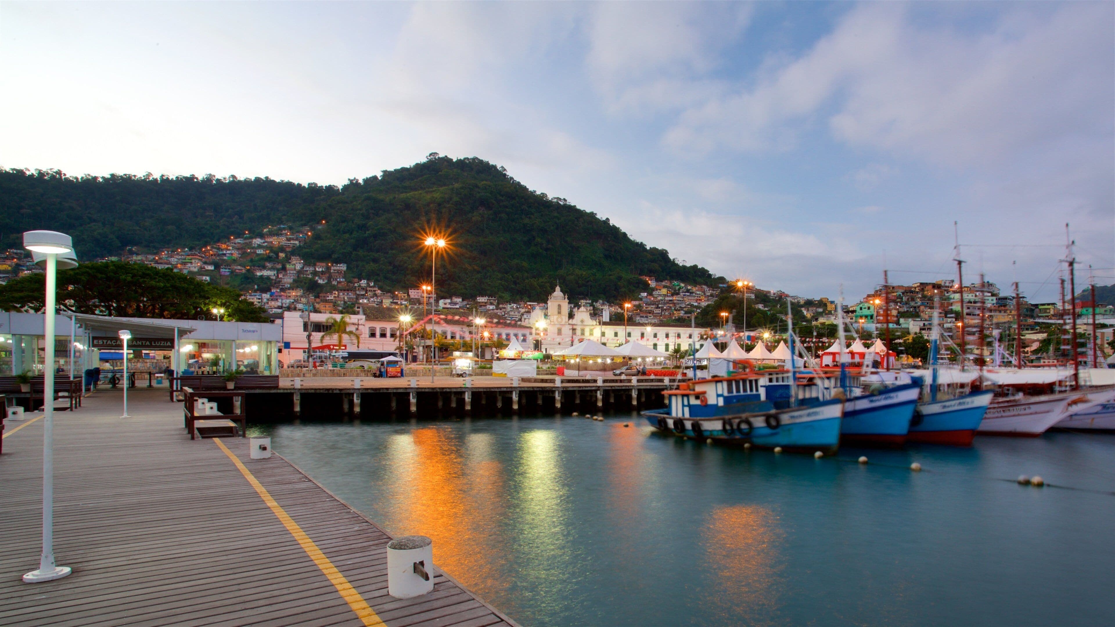 Cais Turistico de Santa Luzia which includes a bay or harbour and a small town or village