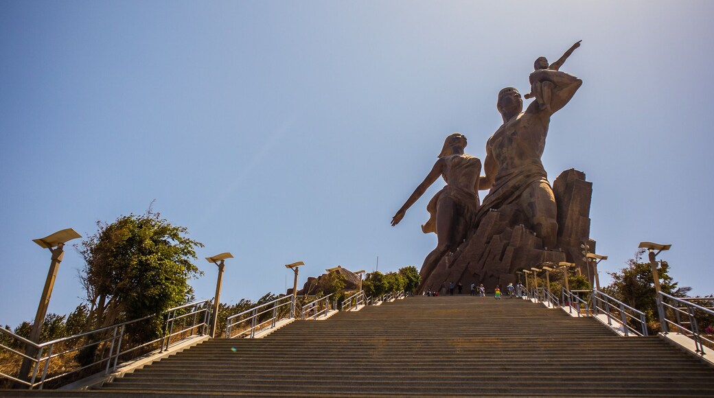 The statue of african renaissance or "monument de la renaissance africaine" on a sunny february day in Dakar, Senegal. View from the bottom of the stairs leading up.