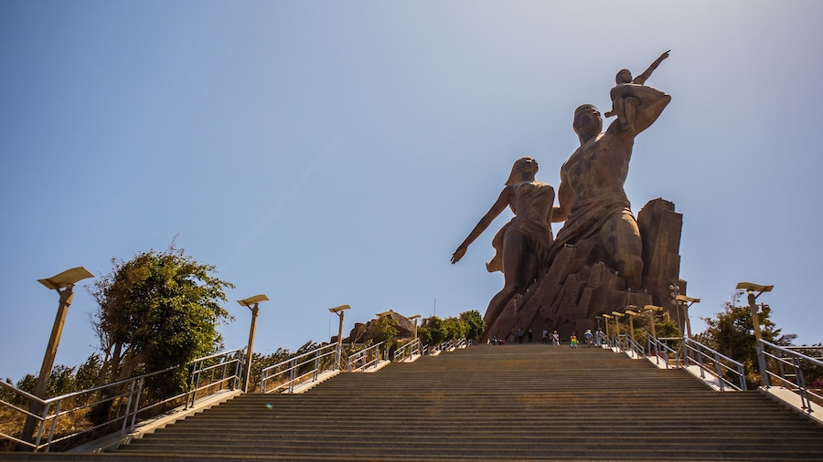 The statue of african renaissance or "monument de la renaissance africaine" on a sunny february day in Dakar, Senegal. View from the bottom of the stairs leading up.
