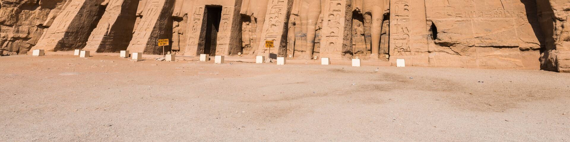 Un templo de arenisca grande con jeroglíficos y una serie de columnas altas y delgadas.
