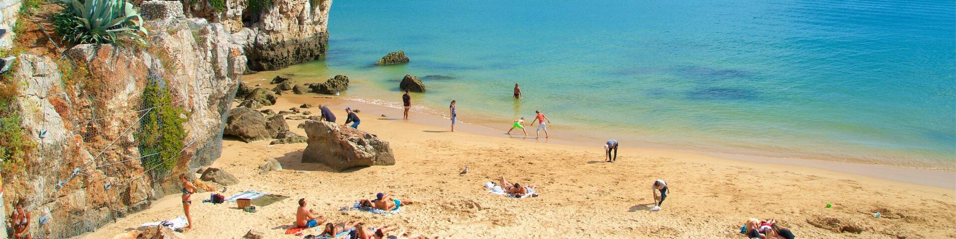 Rainha Beach showing rugged coastline, a sandy beach and general coastal views