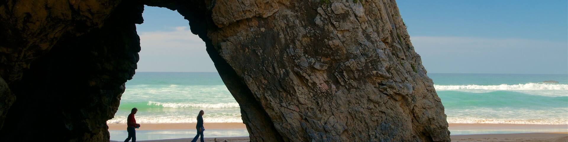 Adraga Beach featuring rocky coastline, a beach and surf