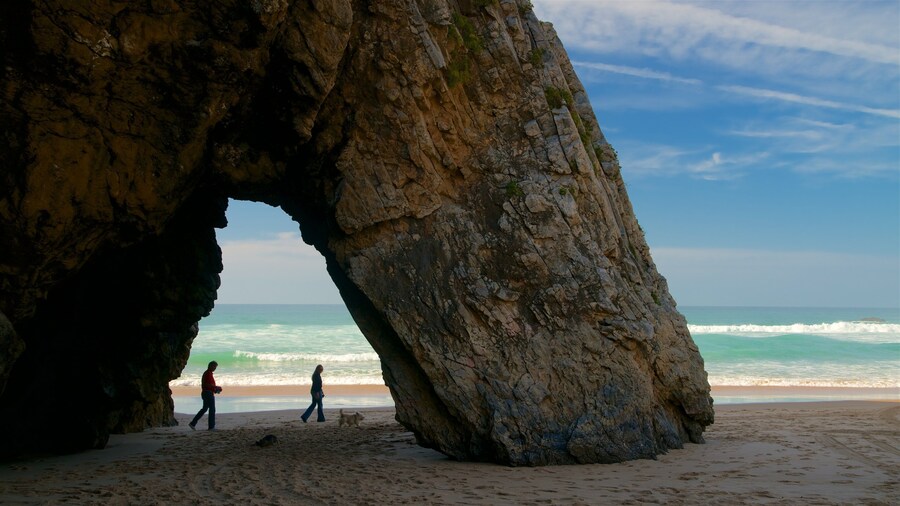 Adraga Beach featuring rocky coastline, a beach and surf