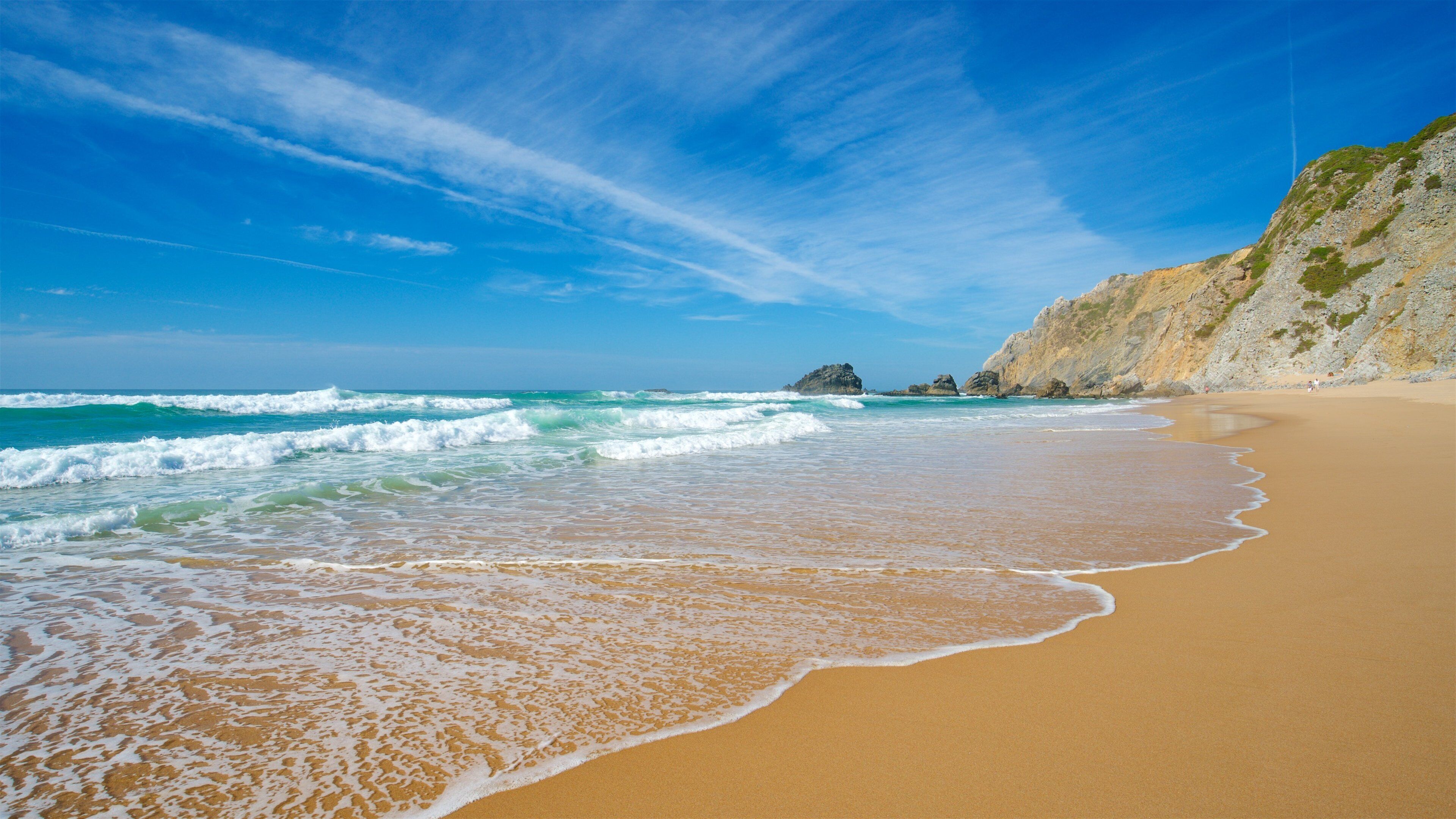 Adraga Beach showing rocky coastline, general coastal views and a sandy beach