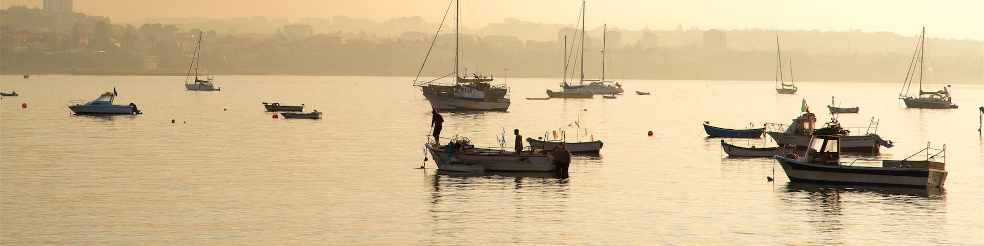Cascais which includes a sunset and a bay or harbor