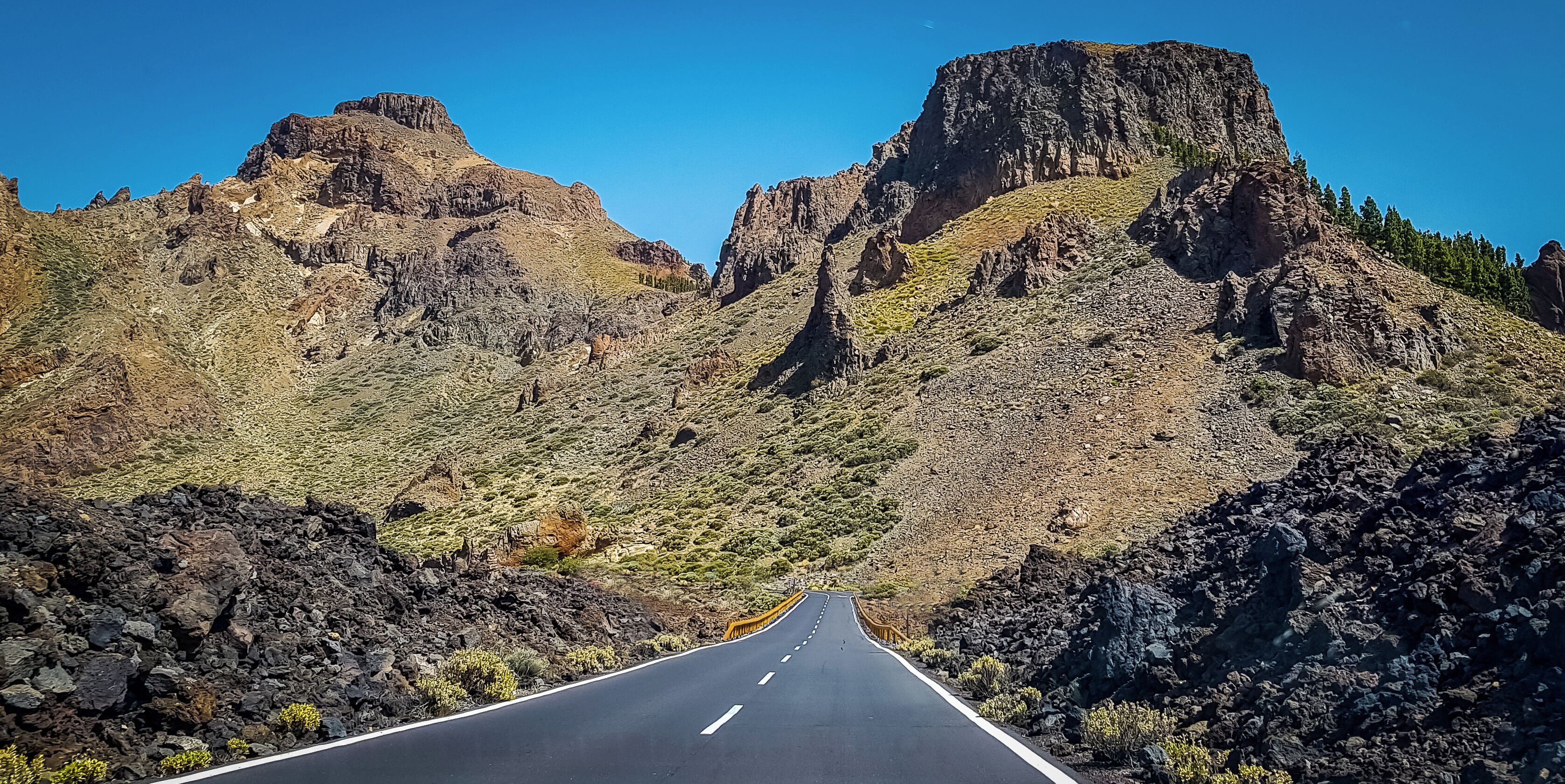 On this road you can drive through a black lava field. The mountains are the rim of the volcanic crater. The floor of the crater slumped many years ago. 

The black lava was from an eruption from Pico Viejo in 1798. The black lava covered an area of about 5km2

#OnTheRoad

