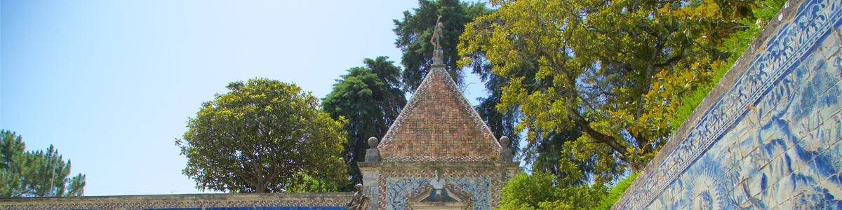A staircase leading to a tiled building with a statue on top.