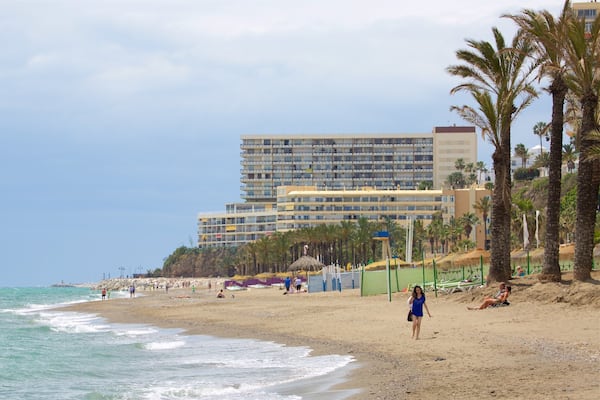 Torremolinos showing tropical scenes, a beach and a coastal town