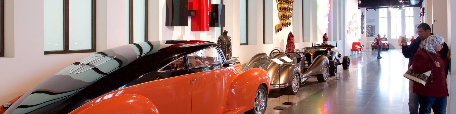 A museum with vintage cars on display.