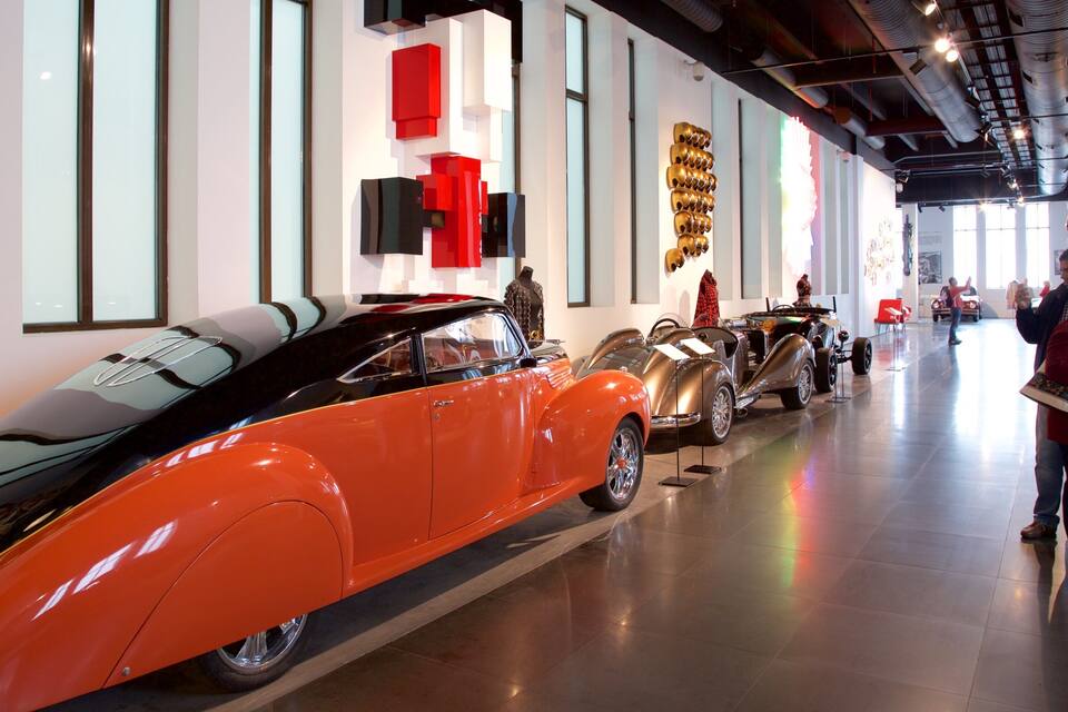 A museum with vintage cars on display.