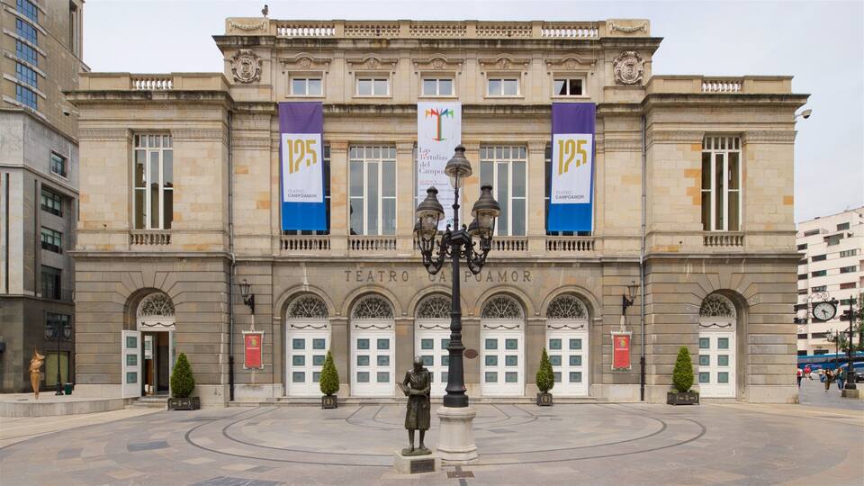 A historic building with banners reading "Teatro Campoamor" and "Teatro Campoamor" in front of it.