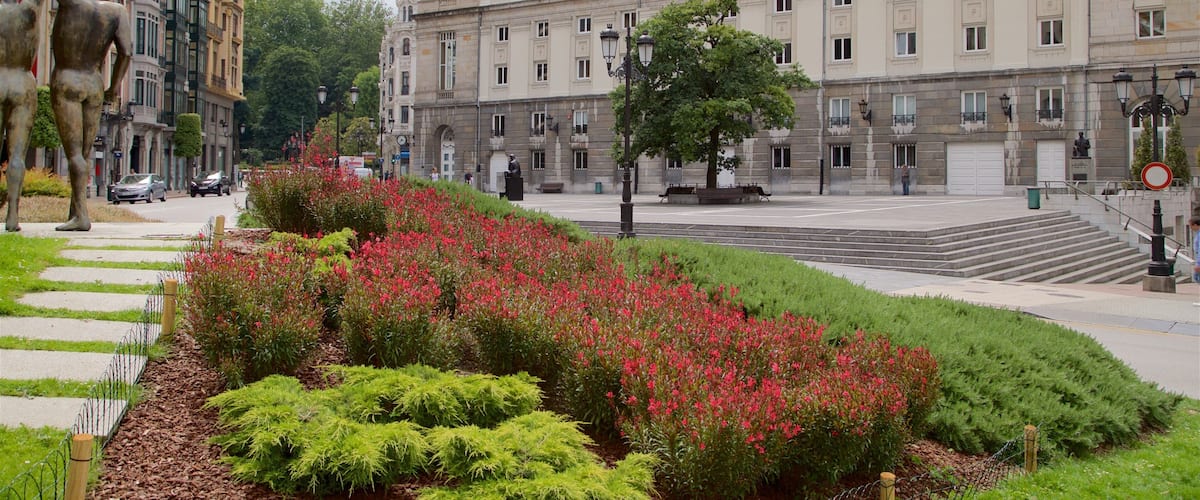 Campoamor Theater which includes outdoor art, flowers and a city