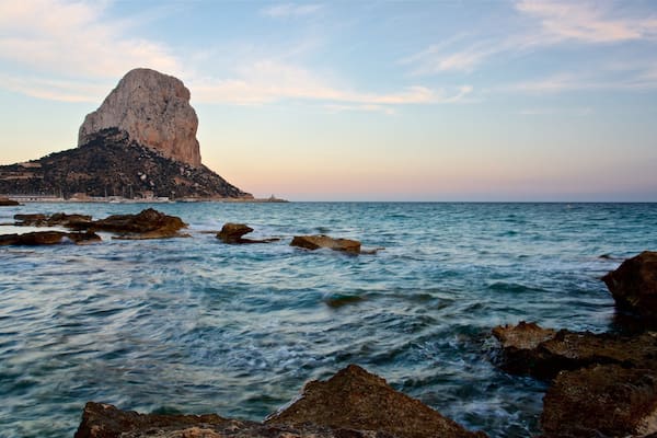 Banos de la Reina Archaelogical Site which includes a sunset, general coastal views and rocky coastline