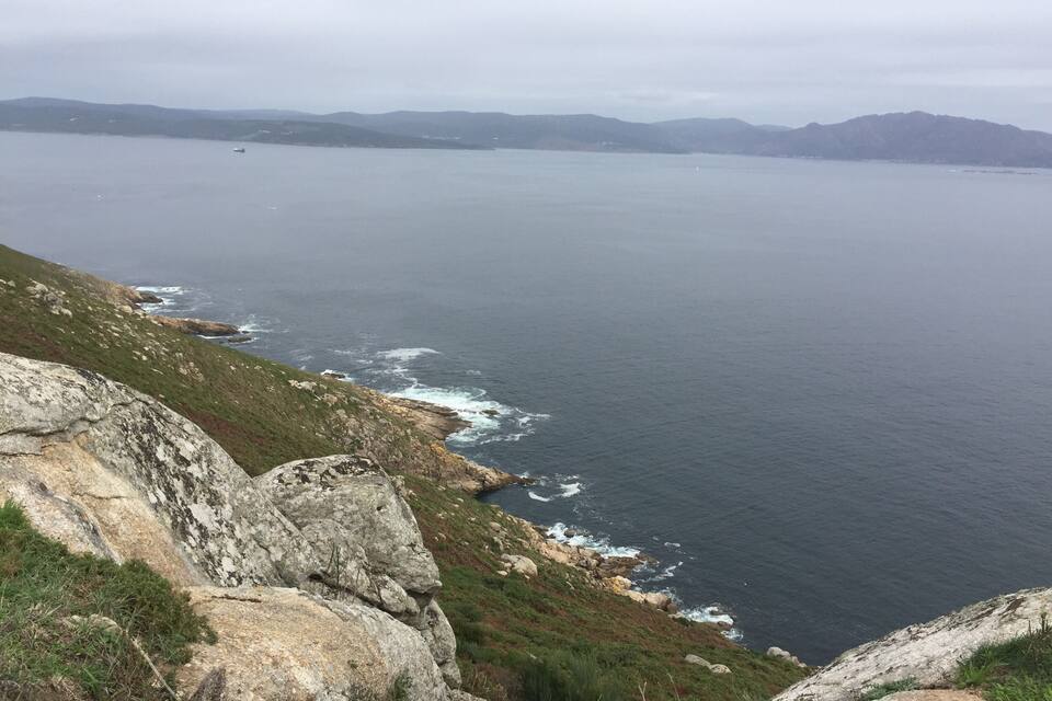 A coastal landscape with rocky cliffs and the ocean.