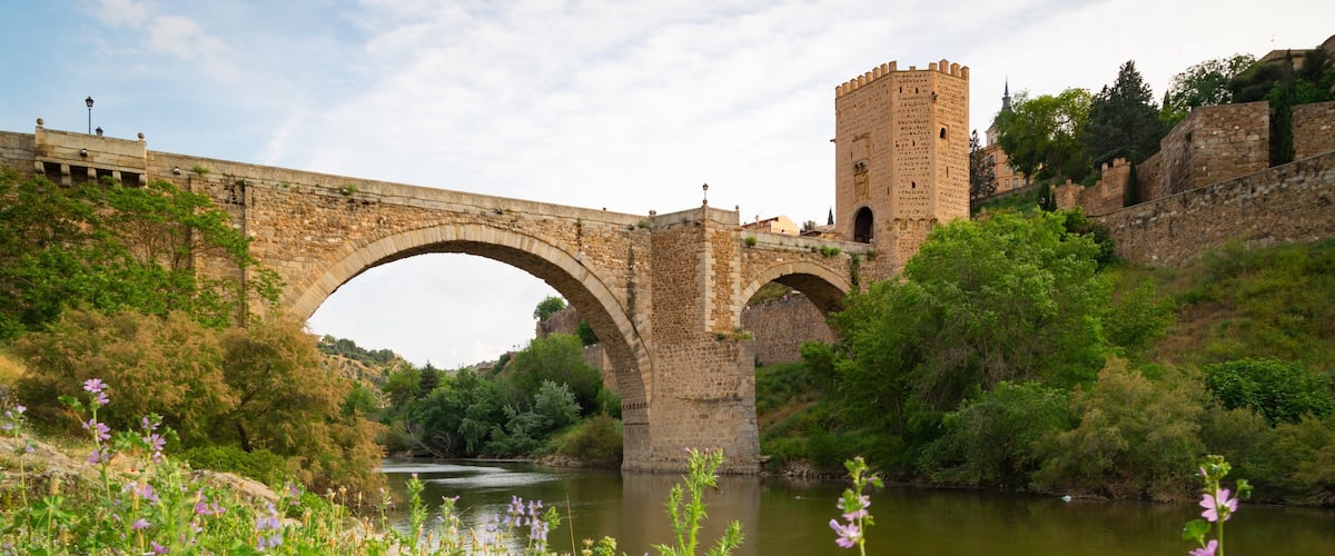 Puente de Alcantara featuring a river or creek, a bridge and heritage elements