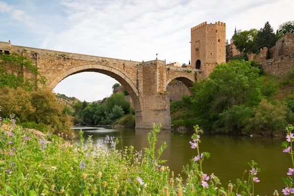 Puente de Alcantara featuring a river or creek, a bridge and heritage elements