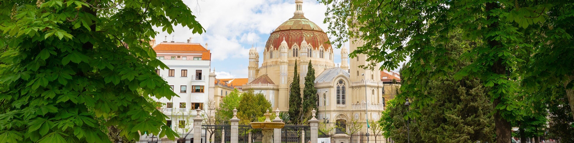 Church of San Manuel y San Benito featuring heritage architecture and a park