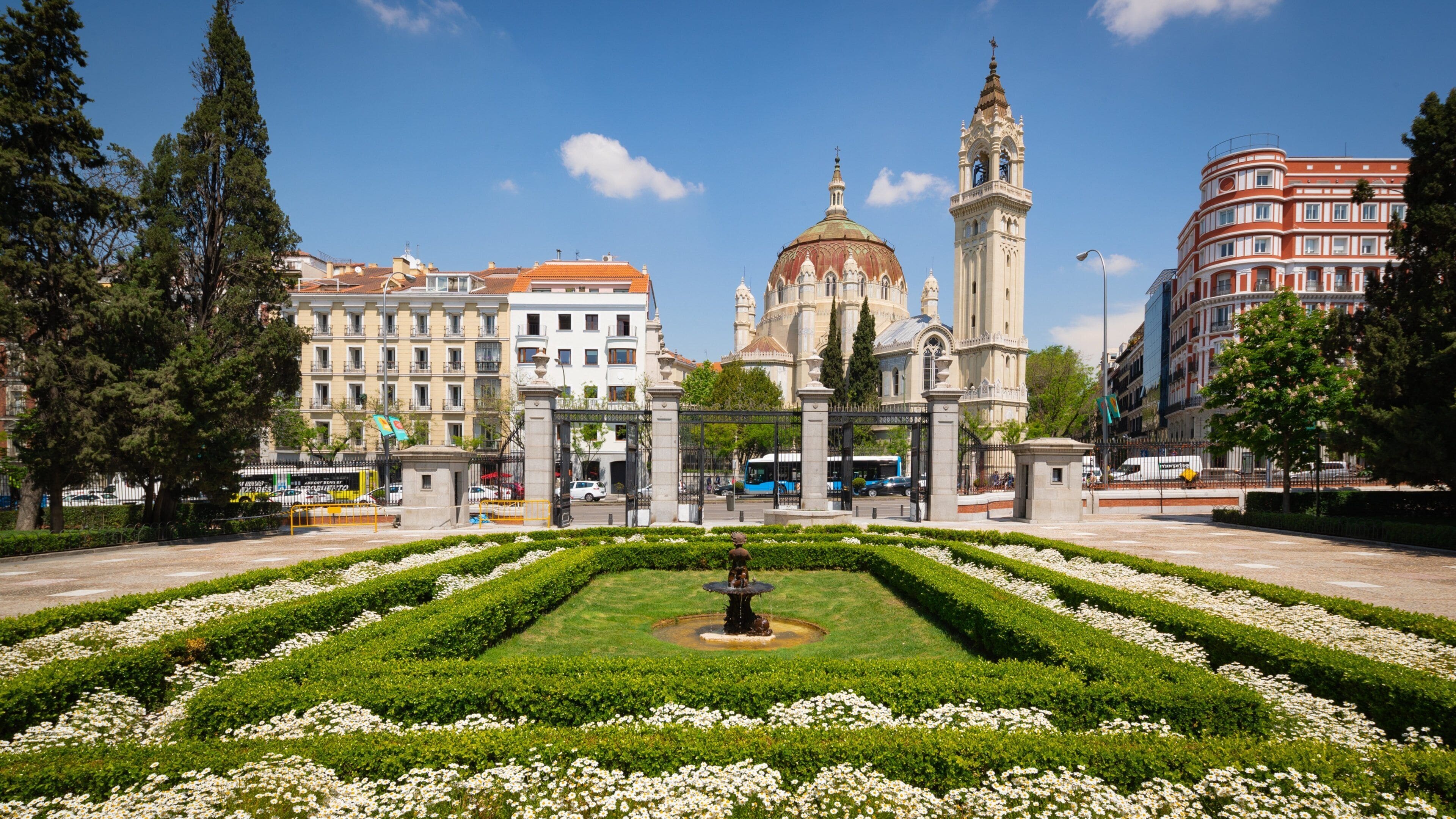 Church of San Manuel y San Benito featuring flowers, a park and heritage architecture
