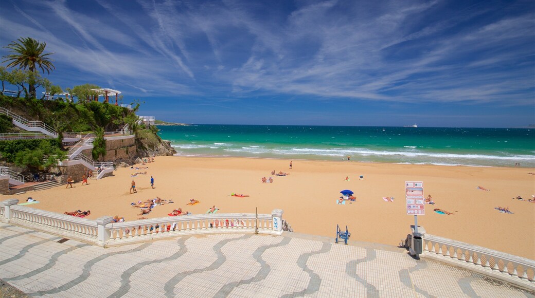 Jardines de Piquio showing a beach and general coastal views as well as a small group of people