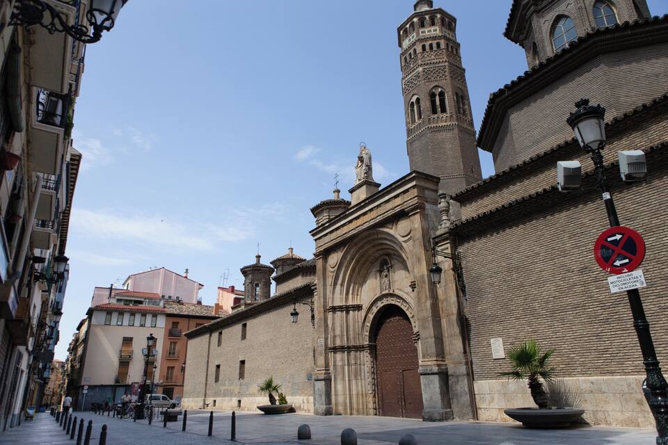 A historic building with a prominent arched entrance and a tall tower.