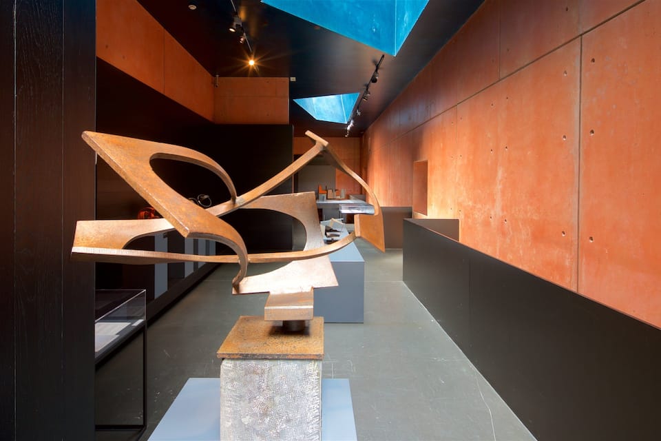 An art installation with abstract metal structures in a modern gallery.