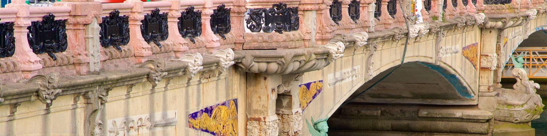 A stone bridge with ornate carvings and colorful mosaic tiles.